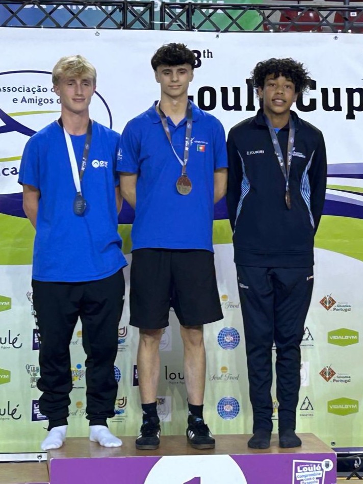 Joshua Mawuena stands far right with the bronze junior mens tumbling medal at the 2025 Loule Cup.