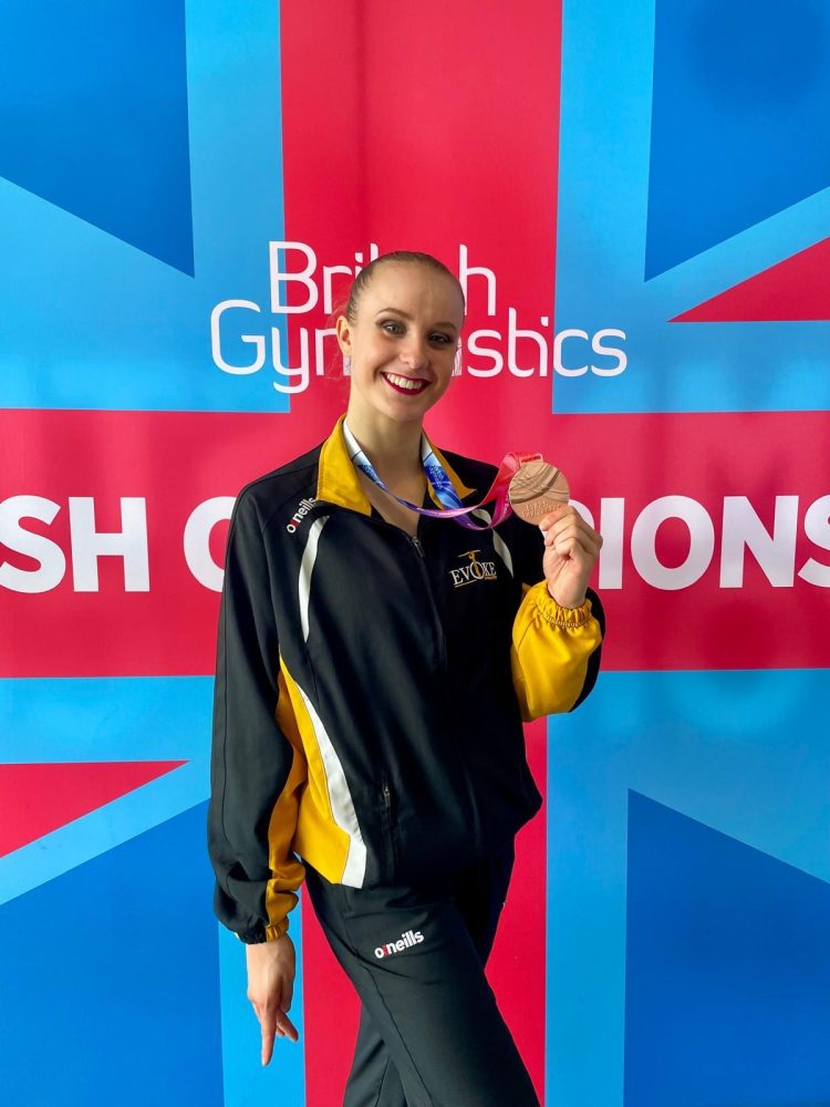 Cara Mackay holding her bronze medal for clubs at the 2025 British Rhythmic Championships
