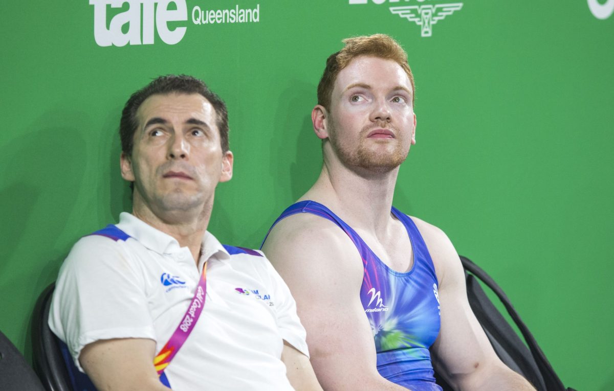 Marius Gherman and Dan Purvis sitting looking up at scoreboard during the Gold Coast 2018 Commonwealth Games